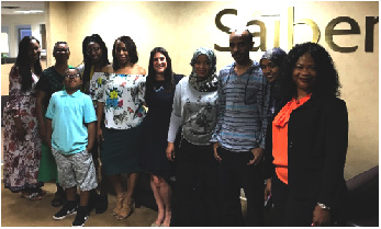 Saiber Counsel Geri Albin accompanies a family of new homeowners after the closing of their new home at Saiber’s Newark office.